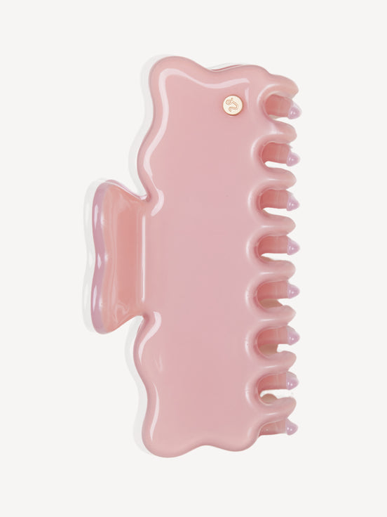 A glossy light pink cellulose acetate hair claw clip, shown from a top-down view on a clean white background.